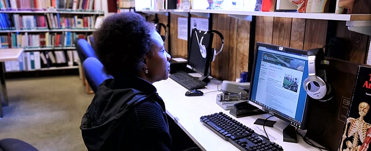 Picture of a student at a computer in the CSTCM library.